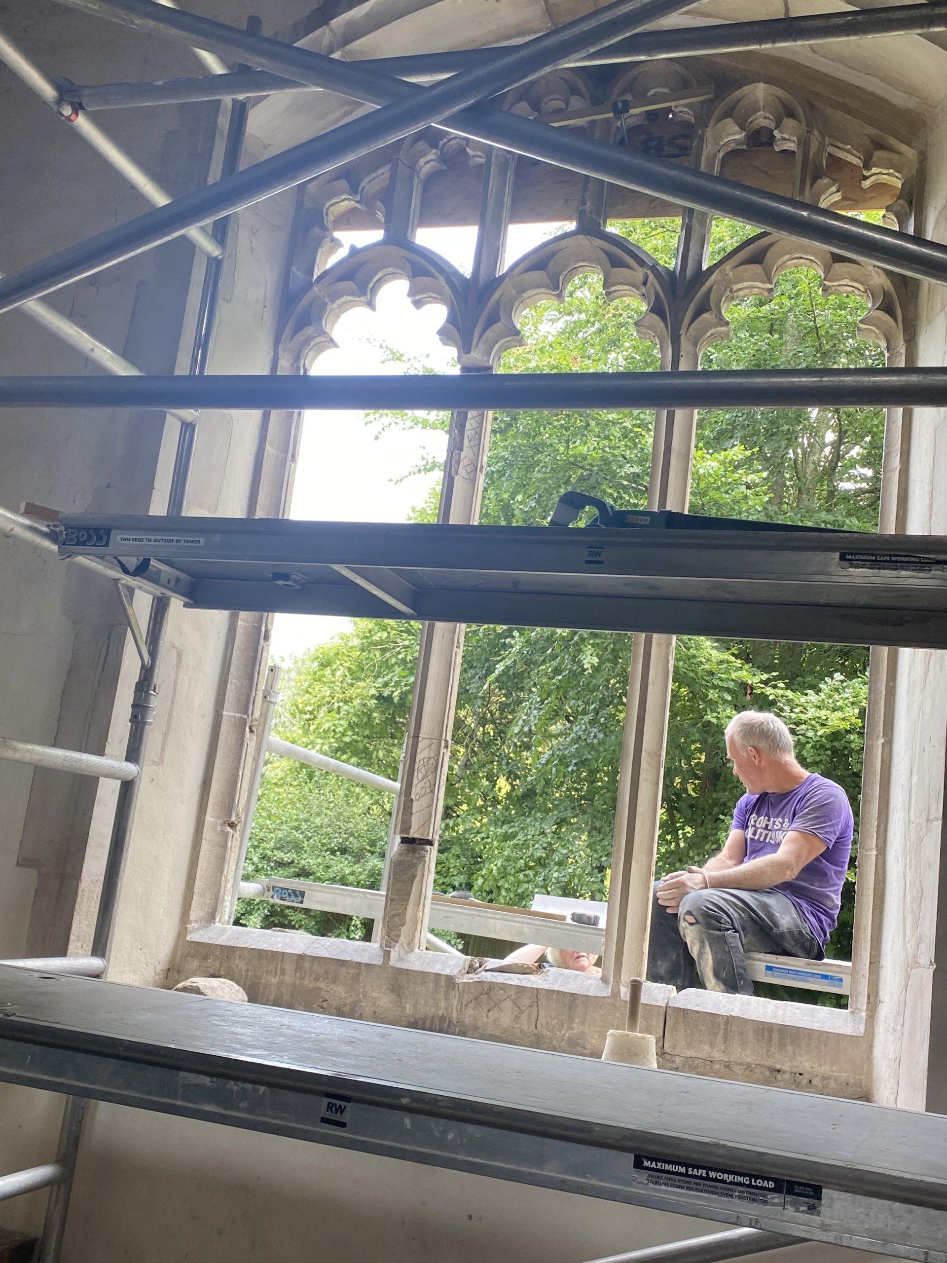 The stonemason at work on one of the windows
